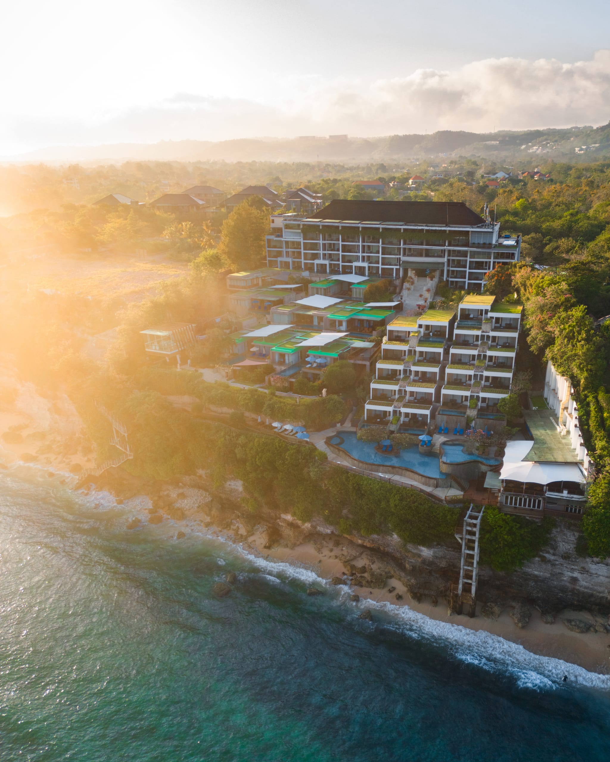 Aerial view of Svanata Uluwatu terraced clifftop resort above the Indian Ocean