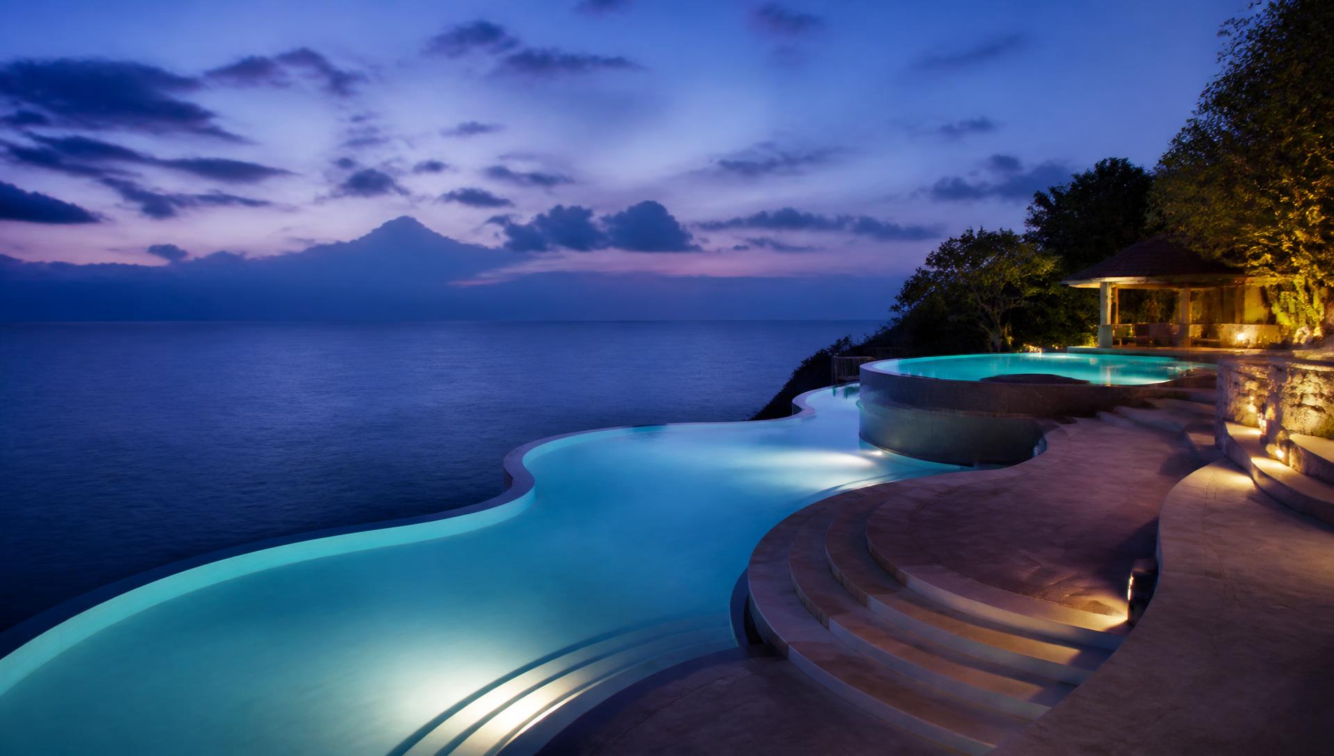Multi-level infinity pool above the Indian Ocean at blue hour